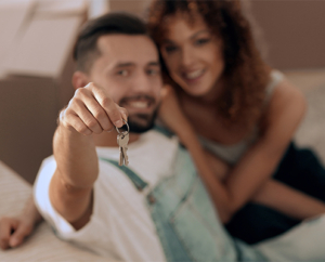 Couple holding up new house keys